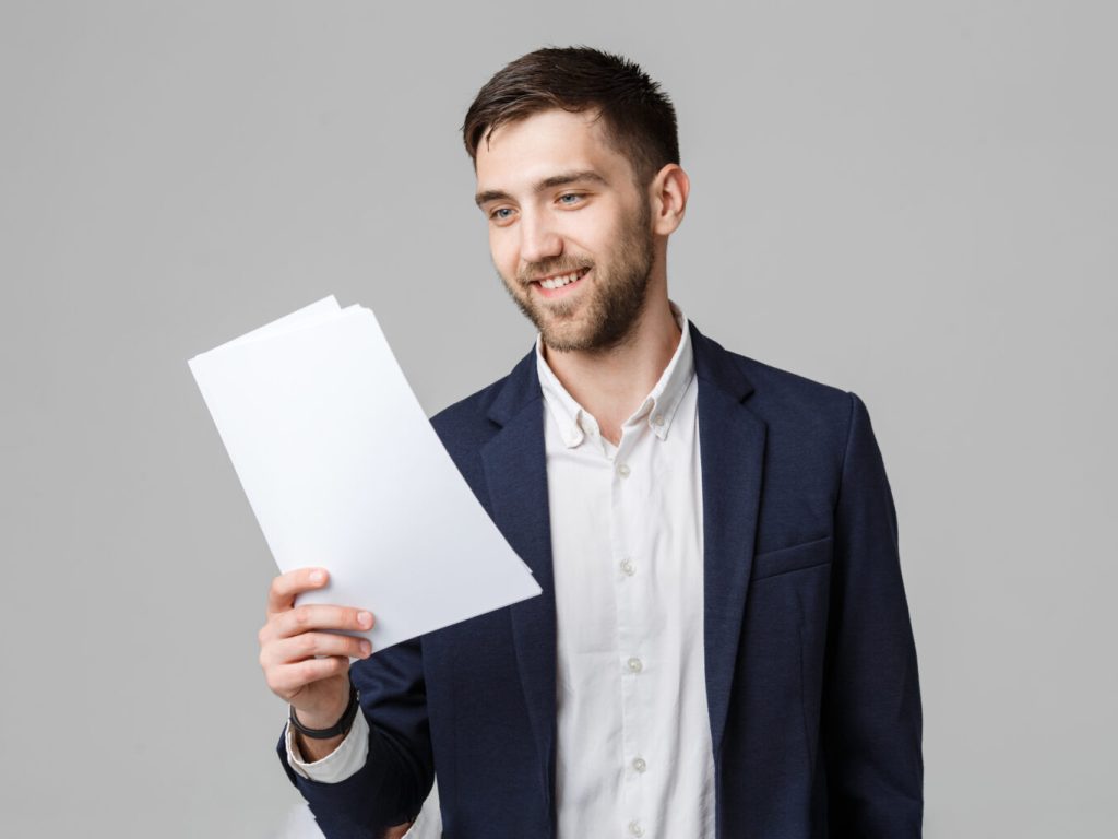 Business Concept – Portrait Handsome Business man happy working with annual report. White Background. Copy Space. Business Concept - Portrait Handsome Business man happy working with annual report. White Background. Copy Space.